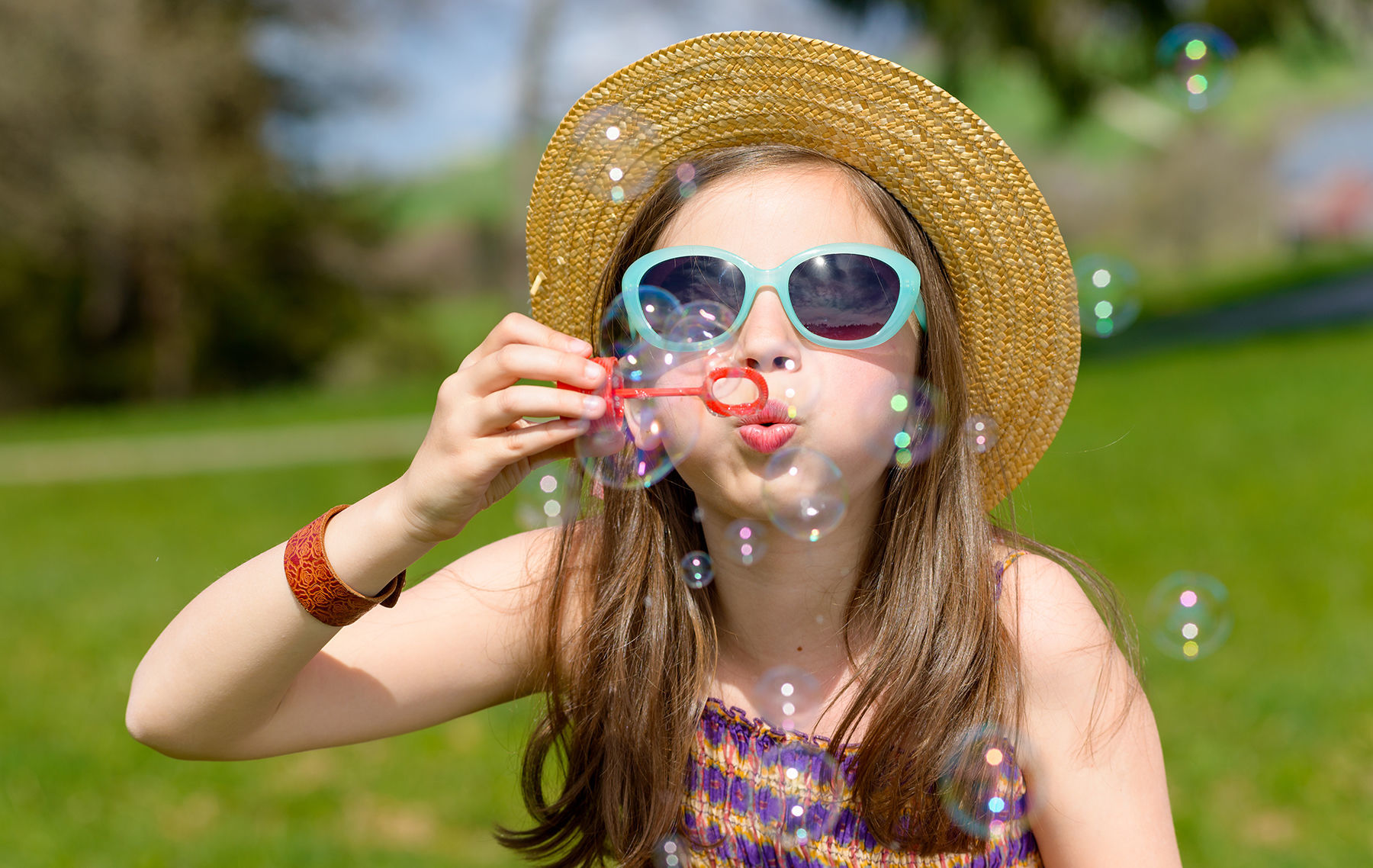 a little girl making soap bubbles